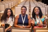 Three young women sitting in an auditorium at the Baobab Summit 2025