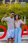 Two young people showing peace signs and smiling