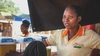Lucy Aciro working at her fresh juice stand