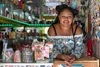 Woman smiling to camera leaning on a counter bar top