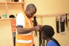 William braiding a woman's hair