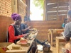 Skilled workers focused on crafting handmade brushes in a workshop