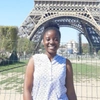 Miriam Odonkor stood smiling to camera in front of the Eiffel Tower