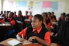 Students seated at their desks in a classroom.