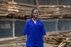 A young woman in blue coveralls