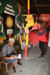 Scholar Favourite Regina, right, takes a moment to admire the art by New Roots, an artists studio at Kyangwali. Justin, left, is one of the artists leading the cooperative.