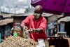 Edwin Ndeke bagging up food at a market.