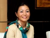Ms. Atsuko Toda, Senior Director, Entrepreneurship Development, Pan-African Programs, Mastercard Foundation wearing a cream coloured shirt with a blue scarf