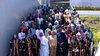  A large group of people gathered for a group photo outdoors on a large staircase