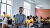 Woman stands smiling to camera 