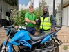 Powerhive CEO Christopher Hornor and Manasse Akhwale, a rider recently financed by 4G Capital stand in front of an electric motorbike shaking hands