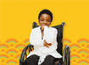 Stephanie Egharevba in her wheelchair in a long sleeved white button up shirt.