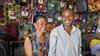 Adele and Jean-Marie standing in their tailor shop