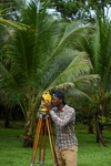 Easu Higenyi working outdoors surveying the land