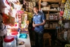 A smiling man standing in a shop.