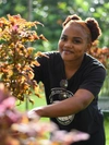Melissa Moyo working on her plants outdoors 