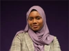 Adja Boudy Kanté in a lilac coloured head scarf and light beige blazer