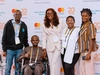 Four young participants at the Young Africa Works Summit in Rwanda, Kigali 2026 wearing business attire and smiling together.