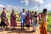 Grace Aipa in Northern Kenya with a group of women pastoral farmers dance outdoors