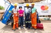 Four people standing for a picture Infront of a mastercard foundation banner