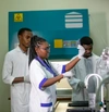 People in lab coats working together