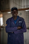 Joseph Lokundu Charles in a dark blue coverall