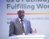 Adrian Bukenya, Country Director, Uganda Programs addresses the crowd at the Young Africa Works Dialogue, 2025 in Uganda, Kampala