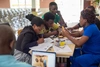 Group of students sat together working on a tech project