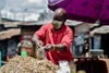 Edwin Ndeke bagging up food at a market