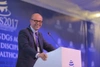 Philip Cotton stood smiling at a talk into a microphone 