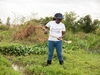 Pauline Orondo with a ‘dipper’ for monitoring the presence of mosquito larvae after sampling from the water.