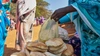Sekina Hassen bagging some of her bread for sale at a market, Inkomoko 2026