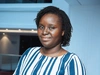 Grace Adjoua Divine, Young Refugee, Togo in a blue and white striped shirt