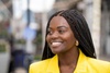 Sherrie Silver, IFAD Advocate for Rural Youth smiling in a bright yellow blazer