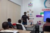 Oliver Mensah leading a training session standing at the front of a class with students facing him