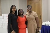Three young woman standing together in smart business attire at a Mastercard Foundation Associates Program event in Nigeria, 2025.