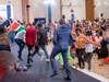 Baobab Summit 2025 attendees celebrating at the flag ceremony on stage and in the audience