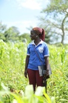 Scholar Favourite Regina stood in a field smiling 