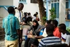A group of young people having a discussion in a courtyard outdoors