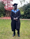 John Bok Chol in his graduate outfit and cap at graduation.