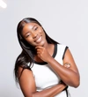 Precious Gozwa in a white structured dress with black edging