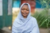 Pang Ismail, wearing a light blue head scarf, in Kakuma refugee camp, 2026.