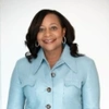 Robin Washington smiling to camera in a light blue jacket