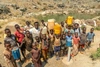 Oliver with a group of young people holding fresh drinking water containers