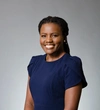 Lynnet Hamblin, UBC 2018 Mastercard Foundation Alumni wearing a dark blue short sleeved structured top