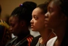 Close up of three Baobab scholars' faces listening to a talk