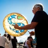 A man playing a traditional drum.