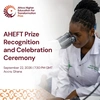 The AHEFT Prize Recognition Ceremony Poster, showing the logo for the prize, with an image of a young woman looking into a microscope wearing a white lab overcoat.