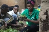 Kevin Githuku, Safali Libia and Kataike Viola at the project site in Kyangwali Refugee Settlement in Uganda planting up plants together