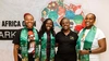 Four young women, including Christine Ng’ang’a, Co-founder of Soko Kijiji, all wearing branded silk green Soko Kijiji branded scarves and smiling brightly.